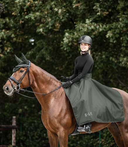 Spódnica do jazdy konnej ELT Lotta w kolorze dark olive zaprezentowana przez modelkę podczas jazdy konnej