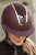 Kask jeździecki Harry's Horse Mont Sparkle w kolorze bordowym/rosegold zaprezentowany przez modelkę