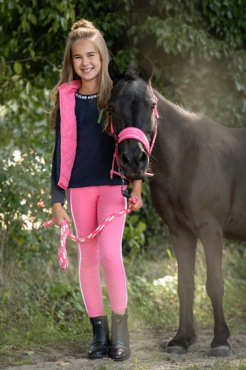Dwustronna kamizelka jeździecka dla dziecka HKM Junior Maui w kolorze różowo-granatowym zaprezentowana przez modelkę